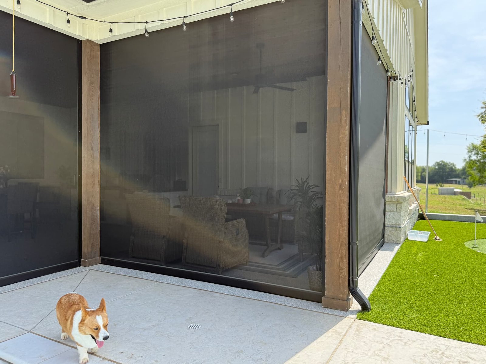 Motorized zip screens enclosing a covered Texas patio, helping create a protected outdoor living space while maintaining natural light and visibility.