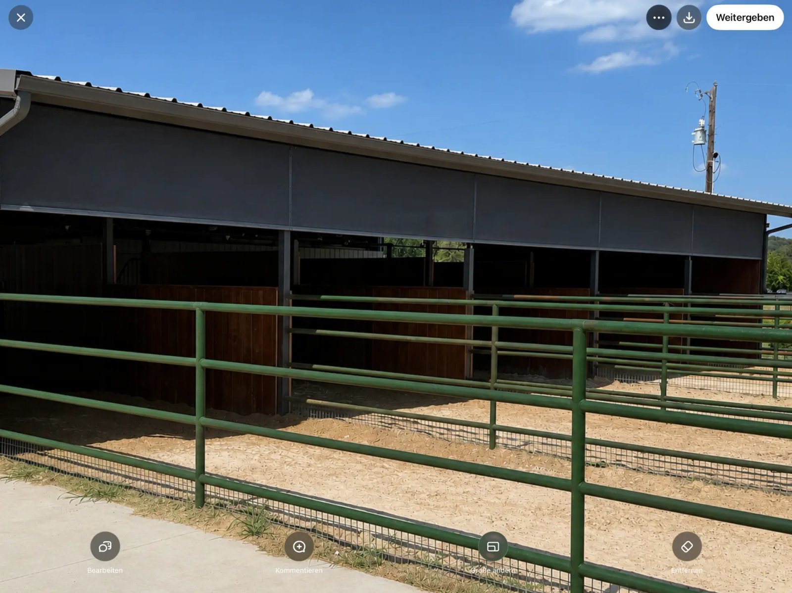 Barn shade screens installed on a Texas horse barn, protecting horses from wind, dust and harsh sun while allowing natural airflow.
