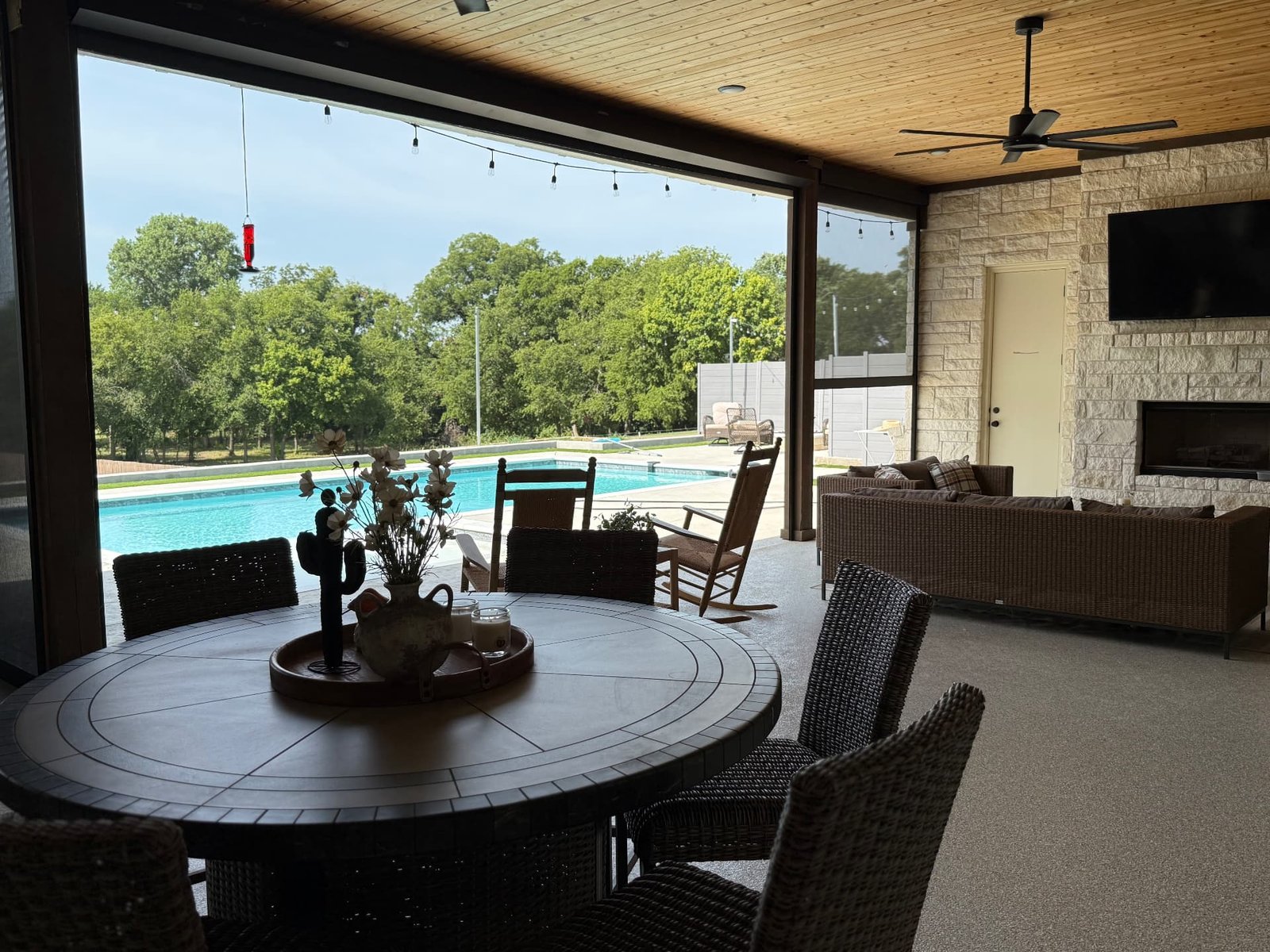 Retractable patio screens on a covered Texas terrace creating a comfortable outdoor living space with shade and protection from insects.