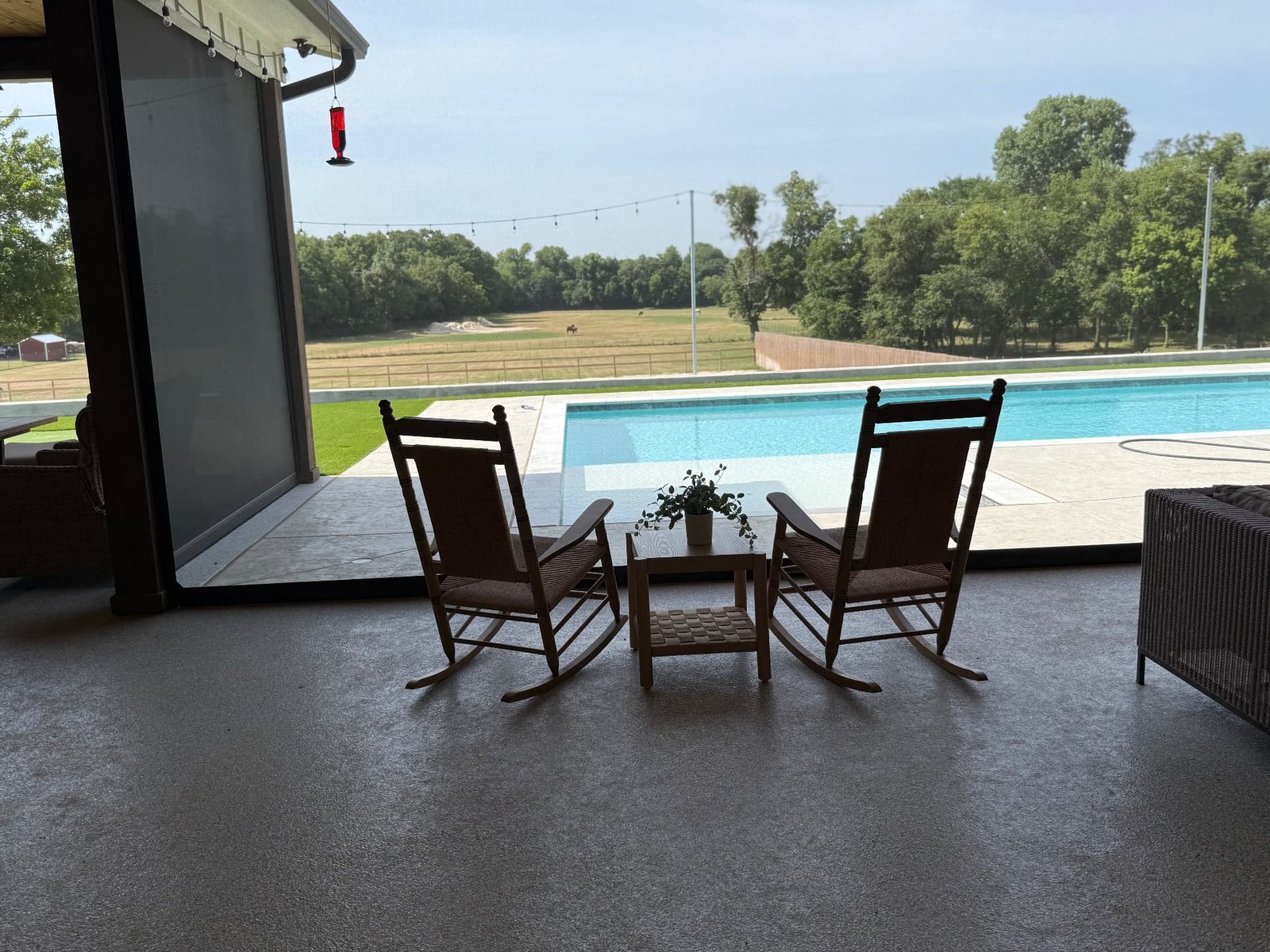 Outdoor patio screens on a Texas outdoor living area, providing shade while preserving the view and open-air atmosphere.